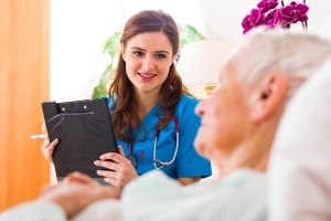 Young nurse speaking with an elderly man